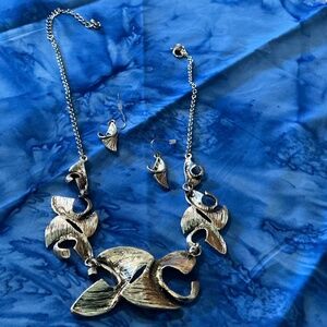 Metal necklace and earrings.